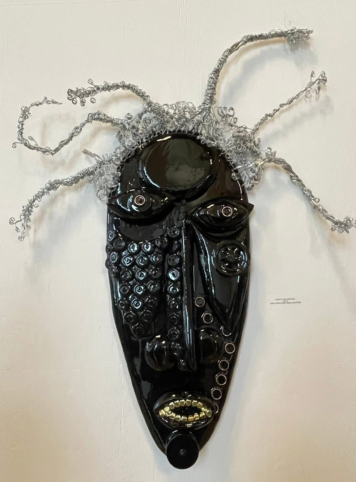 Black mask with decorative elements on a white background